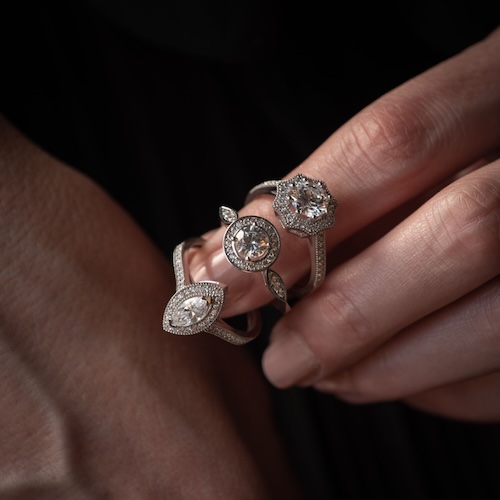 three diamond rings on woman's finger