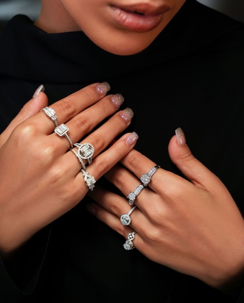 woman wearing diamond rings on each finger