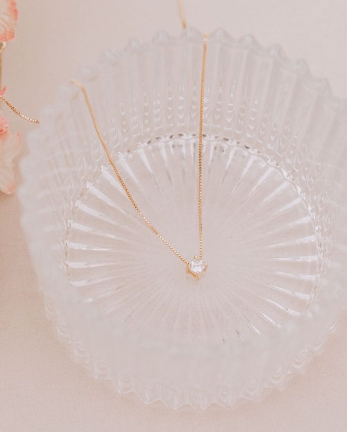 diamond necklace laying in crystal bowl