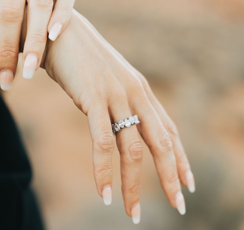 diamond wedding band on woman's finger